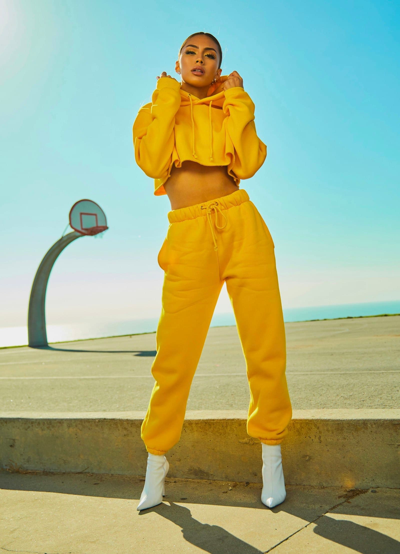Yellow tracksuit on a seaside basketball court